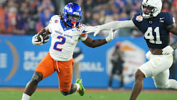 Boise State Broncos running back Ashton Jeanty runs past Penn State Nittany Lions linebacker Kobe King.
