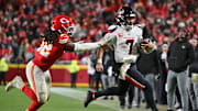 Dec 7, 2025; Kansas City, Missouri, USA; Houston Texans quarterback C.J. Stroud (7) runs the ball against Kansas City Chiefs linebacker Nick Bolton (32) during the fourth quarter at GEHA Field at Arrowhead Stadium. Mandatory Credit: Amy Kontras-Imagn Images