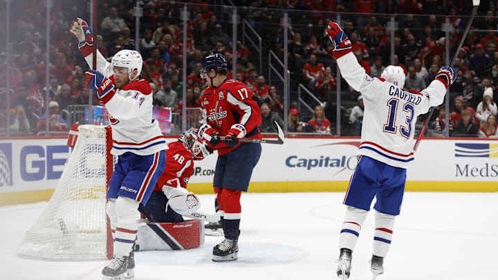 Jan 10, 2025; Washington, District of Columbia, USA; Montreal Canadiens center Nick Suzuki (14) celebrates after scoring the game-winning goal in overtime on Washington Capitals goaltender Logan Thompson (48) at Capital One Arena. Mandatory Credit: Geoff Burke-Imagn Images