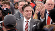  St. John's head coach Rick Pitino gestures towards campus minister for athletics Richard Rock to down the net after defeating the Creighton Bluejays to win the Big East Tournament at Madison Square Garden. 