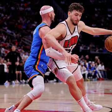 Apr 4, 2025; Houston, Texas, USA; Houston Rockets center Alperen Sengun (28) handles the ball against Oklahoma City Thunder guard Alex Caruso (9) during the second quarter at Toyota Center. Mandatory Credit: Erik Williams-Imagn Images