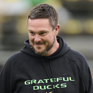 Oct 25, 2025; Eugene, Oregon, USA; Oregon Ducks head coach Dan Lanning encourages players during warm ups before a game against the Wisconsin Badgers at Autzen Stadium. The Ducks are wearing uniforms celebrating the Grateful Dead. Mandatory Credit: Troy Wayrynen-Imagn Images