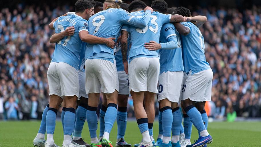 Manchester City’s players celebrate together. 