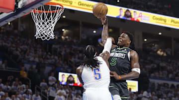 May 20, 2025; Oklahoma City, Oklahoma, USA; Minnesota Timberwolves guard Anthony Edwards (5) drives against Oklahoma City Thunder guard Luguentz Dort (5) in the second quarter during game one of the western conference finals for the 2025 NBA Playoffs at Paycom Center. Mandatory Credit: Alonzo Adams-Imagn Images