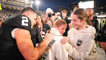 Oct 25, 2025; Nashville, Tennessee, USA;  Vanderbilt Commodores quarterback Diego Pavia (2) sign the back of a fans hoodie against the Missouri Tigers during the second half at FirstBank Stadium. Mandatory Credit: Steve Roberts-Imagn Images