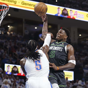 May 20, 2025; Oklahoma City, Oklahoma, USA; Minnesota Timberwolves guard Anthony Edwards (5) drives against Oklahoma City Thunder guard Luguentz Dort (5) in the second quarter during game one of the western conference finals for the 2025 NBA Playoffs at Paycom Center. Mandatory Credit: Alonzo Adams-Imagn Images