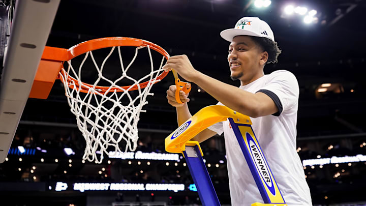 Mar 26, 2023; Kansas City, MO, USA; Miami (Fl) Hurricanes guard Nijel Pack (24) cuts down the net after defeating the Texas Longhorns in an Elite 8 college basketball game in the Midwest Regional of the 2023 NCAA Tournament at T-Mobile Center. Mandatory Credit: Jay Biggerstaff-Imagn Images