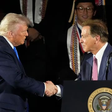 President Donald Trump shakes hands with legendary Alabama football coach Nick Saban before delivering a special commencement address to University of Alabama graduates at Coleman Coliseum on May 1, 2025. Graduation occurs over the weekend.