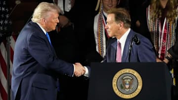 President Donald Trump shakes hands with legendary Alabama football coach Nick Saban before delivering a special commencement address to University of Alabama graduates at Coleman Coliseum on May 1, 2025. Graduation occurs over the weekend.