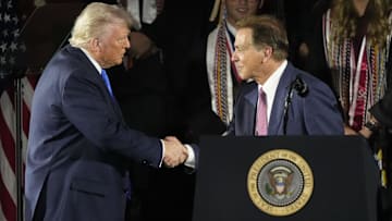 May 1, 2025; Tuscaloosa, AL, USA; President Donald Trump shakes hands with former Alabama football coach Nick Saban before delivering a special commencement address to University of Alabama graduates at Coleman Coliseum. Graduation occurs over the weekend. Mandatory Credit: Gary Cosby Jr.-Tuscaloosa News/USA Today Network via Imagn Images