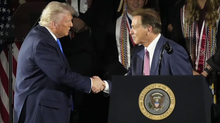 May 1, 2025; Tuscaloosa, AL, USA; President Donald Trump shakes hands with former Alabama football coach Nick Saban before delivering a special commencement address to University of Alabama graduates at Coleman Coliseum. Graduation occurs over the weekend. Mandatory Credit: Gary Cosby Jr.-Tuscaloosa News/USA Today Network via Imagn Images