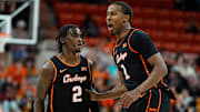 Oklahoma State's Arturo Dean (2) and Bryce Thompson celebrate during the college basketball game between the Oklahoma State University Cowboys and the Southern Illinois Salukis, Thursday, Nov. 14, 2024.