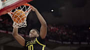 Oregon forward Kwame Evans Jr. (10) dunks the ball as Wisconsin forward Steven Crowl (22) looks on during the first half of their game Saturday, February 22, 2025 at the Kohl Center in Madison, Wisconsin.