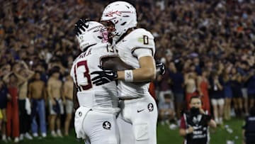 Sep 26, 2025; Charlottesville, Virginia, USA; Florida State Seminoles tight end Randy Pittman Jr. (13) celebrates with Seminoles wide receiver Duce Robinson (0) after catching a game tying touchdown pass in the final minute during the fourth quarter in front of Virginia Cavaliers linebacker Kam Robinson (5) during the fourth quarter at Scott Stadium. Mandatory Credit: Geoff Burke-Imagn Images
