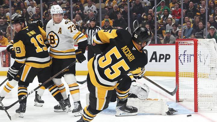Mar 8, 2026; Pittsburgh, Pennsylvania, USA;  Boston Bruins goaltender Joonas Korpisalo (hidden makes a save against Pittsburgh Penguins center Noel Acciari (55) during the first period at PPG Paints Arena. Mandatory Credit: Charles LeClaire-Imagn Images