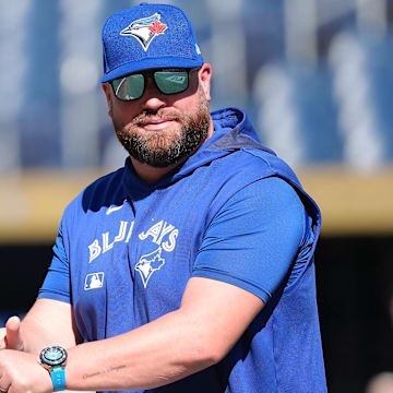 Jul 21, 2025; Toronto, Ontario, CAN; Toronto Blue Jays manager John Schneider (14) walks onto the field during practice before a game against the New York Yankees at Rogers Centre. 