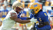 Oct 4, 2025; Pittsburgh, Pennsylvania, USA;  Pittsburgh Panthers linebacker Kyle Louis (9) runs after fumble recovery as Boston College Eagles wide receiver Reed Harris (left) attempts to tackle during the second quarter at Acrisure Stadium. Mandatory Credit: Charles LeClaire-Imagn Images