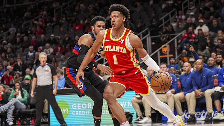Jan 22, 2025; Atlanta, Georgia, USA; Atlanta Hawks forward Jalen Johnson (1) dribbles past Detroit Pistons forward Tobias Harris (12) during the second half at State Farm Arena. Mandatory Credit: Dale Zanine-Imagn Images