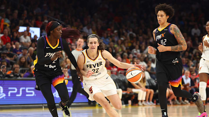 Jun 30, 2024; Phoenix, Arizona, USA; Indiana Fever guard Caitlin Clark (22) against Phoenix Mercury guard Kahleah Copper (2) and center Brittney Griner (42) during a WNBA game at Footprint Center. Mandatory Credit: Mark J. Rebilas-Imagn Images