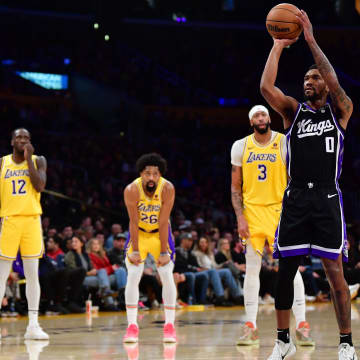 Mar 6, 2024; Los Angeles, California, USA; Sacramento Kings guard Malik Monk (0) takes his technical free throw shot in front of Los Angeles Lakers guard Max Christie (10) forward Taurean Prince (12) guard Spencer Dinwiddie (26) and forward Anthony Davis (3) during the first half at Crypto.com Arena. Mandatory Credit: Gary A. Vasquez-USA TODAY Sports