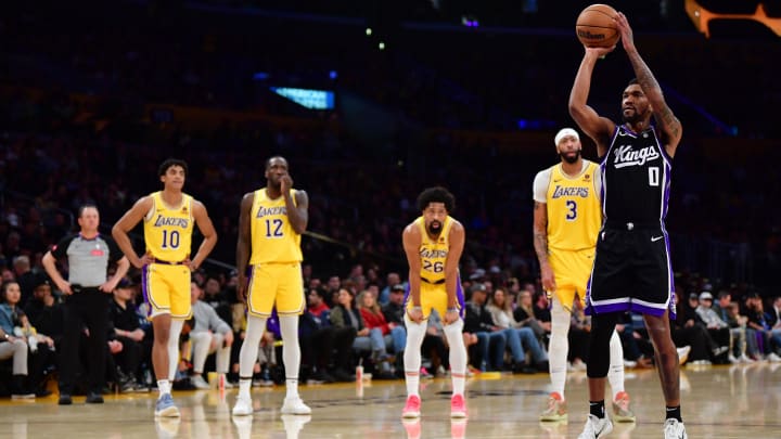 Mar 6, 2024; Los Angeles, California, USA; Sacramento Kings guard Malik Monk (0) takes his technical free throw shot in front of Los Angeles Lakers guard Max Christie (10) forward Taurean Prince (12) guard Spencer Dinwiddie (26) and forward Anthony Davis (3) during the first half at Crypto.com Arena. Mandatory Credit: Gary A. Vasquez-USA TODAY Sports