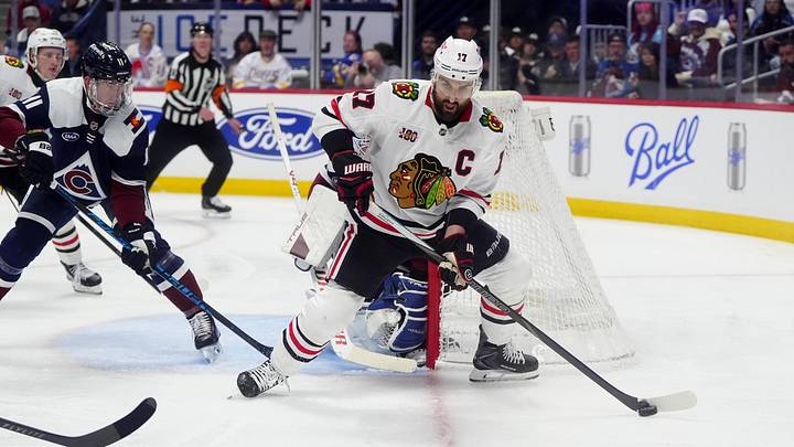 Feb 28, 2026; Denver, Colorado, USA; Colorado Avalanche center Brock Nelson (11) defends on Chicago Blackhawks left wing Nick Foligno (17) in the third period at Ball Arena. Mandatory Credit: Ron Chenoy-Imagn Images