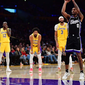 Mar 6, 2024; Los Angeles, California, USA; Sacramento Kings guard Malik Monk (0) takes his technical free throw shot in front of Los Angeles Lakers guard Max Christie (10) forward Taurean Prince (12) guard Spencer Dinwiddie (26) and forward Anthony Davis (3) during the first half at Crypto.com Arena. Mandatory Credit: Gary A. Vasquez-Imagn Images