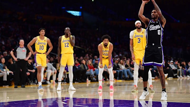 Mar 6, 2024; Los Angeles, California, USA; Sacramento Kings guard Malik Monk (0) takes his technical free throw shot in front of Los Angeles Lakers guard Max Christie (10) forward Taurean Prince (12) guard Spencer Dinwiddie (26) and forward Anthony Davis (3) during the first half at Crypto.com Arena. Mandatory Credit: Gary A. Vasquez-Imagn Images