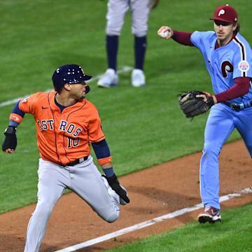 Nov 3, 2022; Philadelphia, Pennsylvania, USA; Houston Astros first baseman Yuli Gurriel (10) is caught in a run-down and tagged out by Philadelphia Phillies first baseman Rhys Hoskins (17) during the seventh inning in game five of the 2022 World Series at Citizens Bank Park.