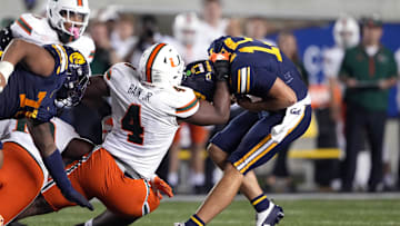 Oct 5, 2024; Berkeley, California, USA; Miami Hurricanes defensive lineman Rueben Bain Jr. (4) sacks California Golden Bears quarterback Fernando Mendoza (right) during the fourth quarter at California Memorial Stadium. Mandatory Credit: Darren Yamashita-Imagn Images