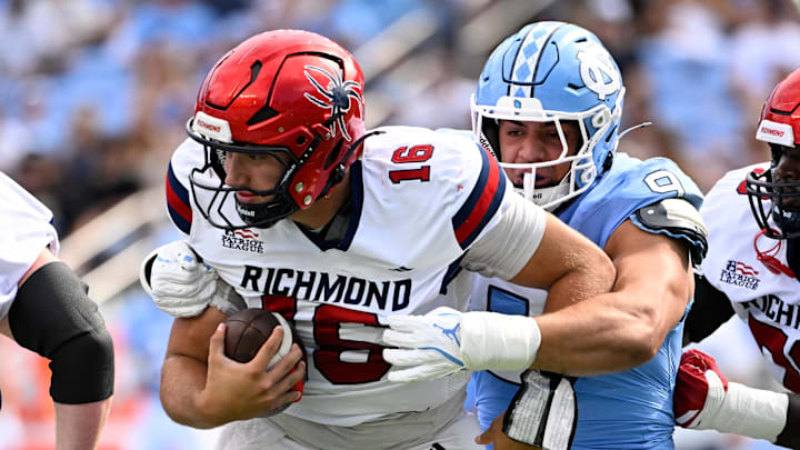 Sep 13, 2025; Chapel Hill, North Carolina, USA; North Carolina Tar Heels defensive lineman Melkart Abou-Jaoude (9) sacks Richmond Spiders quarterback Kyle Wickersham (16) in the first quarter at Kenan Stadium. Mandatory Credit: Bob Donnan-Imagn Images