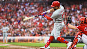 Aug 11, 2025; Cincinnati, Ohio, USA; Philadelphia Phillies designated hitter Kyle Schwarber (12) hits a two-run home run in the eighth inning against the Cincinnati Reds at Great American Ball Park. Mandatory Credit: Katie Stratman-Imagn Images