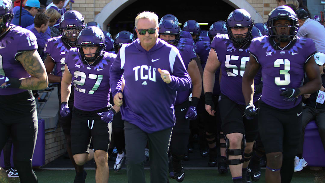 TCU Coach Sonny Dykes leads his team on to the football field