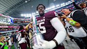 Sep 28, 2024; Arlington, Texas, USA;  Texas A&M Aggies offensive lineman Ar'maj Reed-Adams (55) celebrates with the Southwest Classic trophy after the game against the Arkansas Razorbacks at AT&T Stadium. Mandatory Credit: Kevin Jairaj-Imagn Images