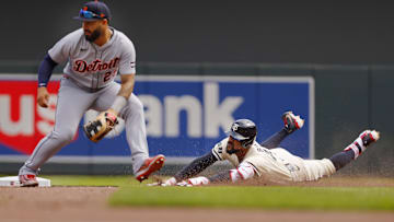 Apr 13, 2025; Minneapolis, Minnesota, USA; Minnesota Twins center fielder Byron Buxton (25) slides into second base for a double as Detroit Tigers second baseman Gleyber Torres (25) awaits the throw in the sixth inning at Target Field. Mandatory Credit: Bruce Kluckhohn-Imagn Images