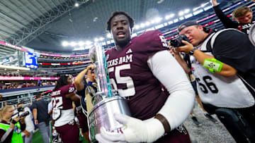 Sep 28, 2024; Arlington, Texas, USA;  Texas A&M Aggies offensive lineman Ar'maj Reed-Adams (55) celebrates with the Southwest Classic trophy after the game against the Arkansas Razorbacks at AT&T Stadium. Mandatory Credit: Kevin Jairaj-Imagn Images