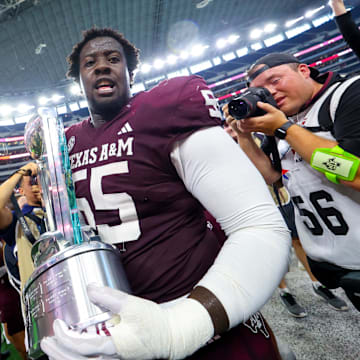Sep 28, 2024; Arlington, Texas, USA;  Texas A&M Aggies offensive lineman Ar'maj Reed-Adams (55) celebrates with the Southwest Classic trophy after the game against the Arkansas Razorbacks at AT&T Stadium. Mandatory Credit: Kevin Jairaj-Imagn Images