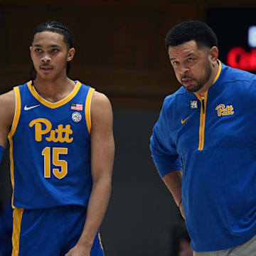 Jan 7, 2025; Durham, North Carolina, USA; Pitt Panthers head coach Jeff Capel (right) talks to guard Jaland Lowe (15) during the first half against the Duke Blue Devils at Cameron Indoor Stadium. Mandatory Credit: Rob Kinnan-Imagn Images