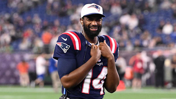 Patriots quarterback Jacoby Brissett (14) walks onto the field during a timeout against the Philadelphia Eagles in the second