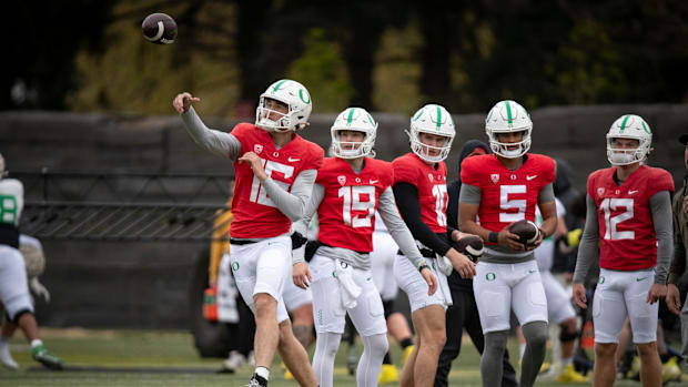 Oregon quarterback Austin Novosad throws as other quarterbacks watch during practice with the Oregon Ducks Saturday, April 6,