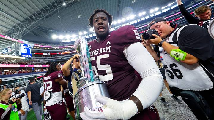 Sep 28, 2024; Arlington, Texas, USA;  Texas A&M Aggies offensive lineman Ar'maj Reed-Adams (55) celebrates with the Southwest Classic trophy after the game against the Arkansas Razorbacks at AT&T Stadium. Mandatory Credit: Kevin Jairaj-Imagn Images