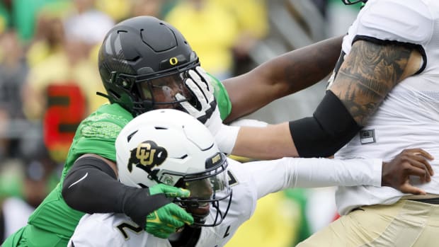 Oregon Ducks defensive end Jordan Burch (1) sacks Colorado Buffaloes quarterback Shedeur Sanders (2) 