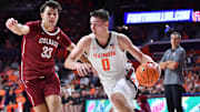 Nov 14, 2025; Champaign, Illinois, USA;  Illinois Fighting Illini forward David Mirkovic (0) drives the ball against Colgate Raiders forward Sam Wright (33) during the first half at State Farm Center. Mandatory Credit: Ron Johnson-Imagn Images