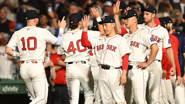 Boston Red Sox shortstop Trevor Story (10) high-fives left fielder Masataka Yoshida (7) after a game against the New York Yankees at Fenway Park.