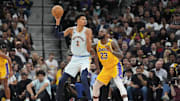 San Antonio Spurs center Victor Wembanyama handles the ball in front of Los Angeles Lakers forward LeBron James.