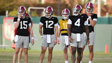 Mar 6, 2024; Tuscaloosa, Alabama, USA; Alabama quarterbacks Ty Simpson (15), Dylan Lonergan (12), Cade Carruth (16), Jalen MIlroe (4) and Austin Mack (10) wait for a drill to begin during practice for the Alabama Crimson Tide football team Wednesday.