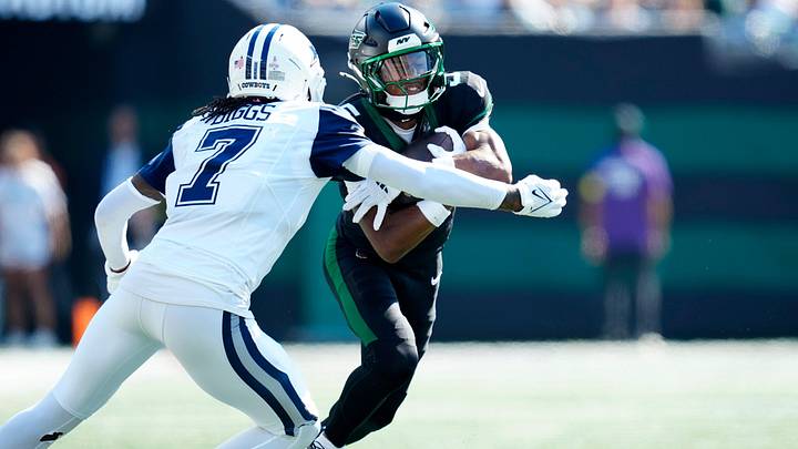 New York Jets wide receiver Garrett Wilson (5) prepares to be tackled by Dallas Cowboys cornerback Trevon Diggs (7), Sunday, October 5, 2025.