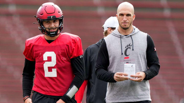 Cincinnati Bearcats quarterback Brendan Sorsby (2), left, smiles during spring football practice, Monday, March 4, 2024, at Nippert Stadium in Cincinnati.