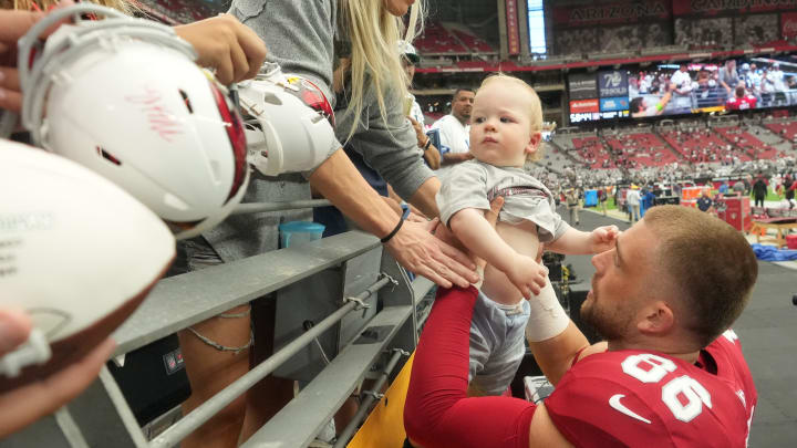 Arizona Cardinals tight end Zach Ertz holds his son Madden Matthew before they play against the Dallas Cowboys at State Farm Stadium in Glendale on Set. 24, 2023.