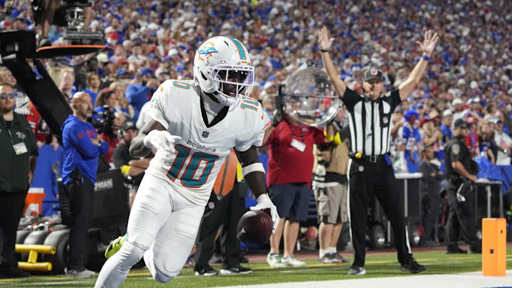 Miami Dolphins wide receiver Tyreek Hill (10) scores a touchdown against the Buffalo Bills in the fourth quarter at Highmark Stadium. 